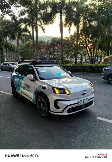 A white HUAWEI Mate60 Pro parked on a street with palm trees and a clear sky in the background. 1
