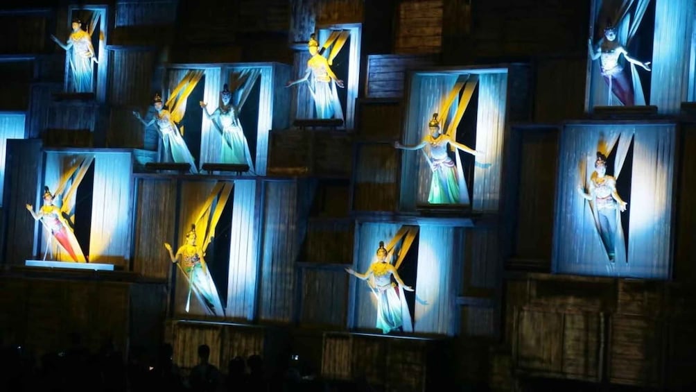 A series of illuminated statues in a darkened room. 1
