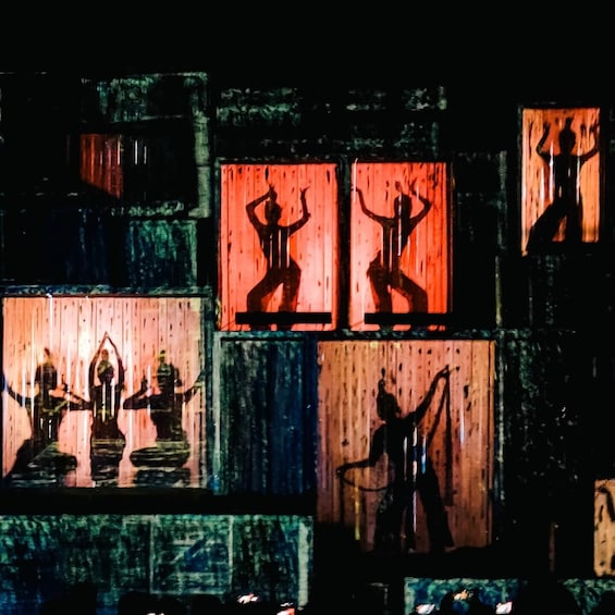 A series of illuminated panels with silhouetted figures. 3