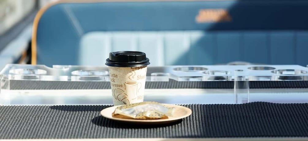 A coffee cup and a pastry on a tray. 2