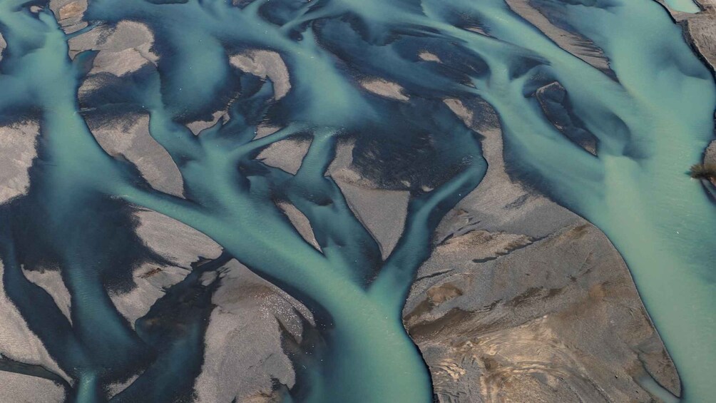 A river with a unique turquoise color flowing through a rocky landscape. 3