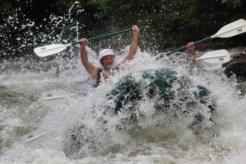 A person kayaking through a turbulent river. 5