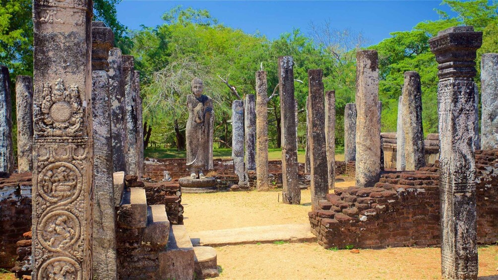 Ancient stone columns and intricate carvings in a historical site. 3