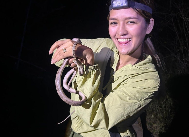 A person holding a snake. 4