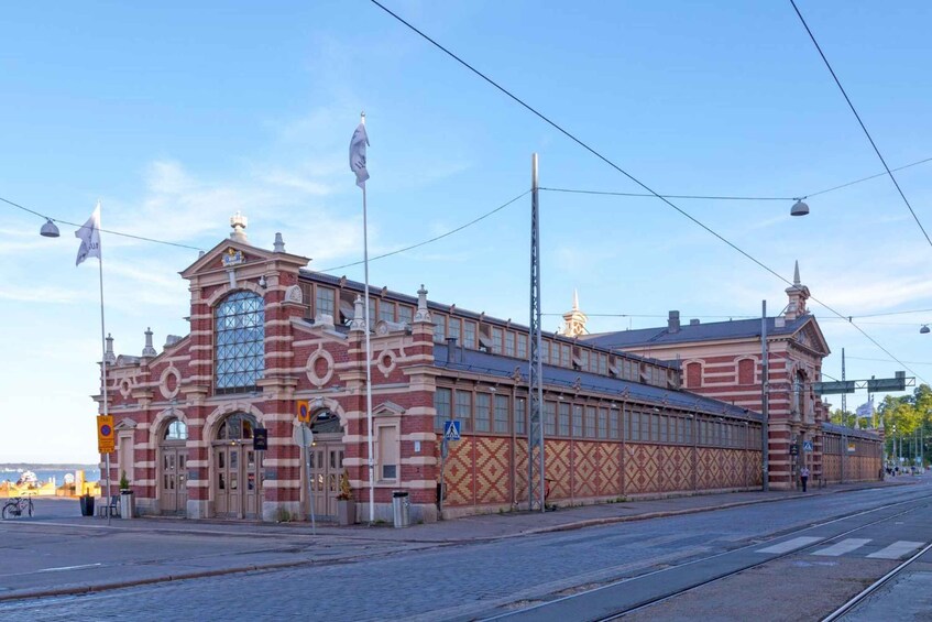 A historic building with a large arched window and a clock tower. 1