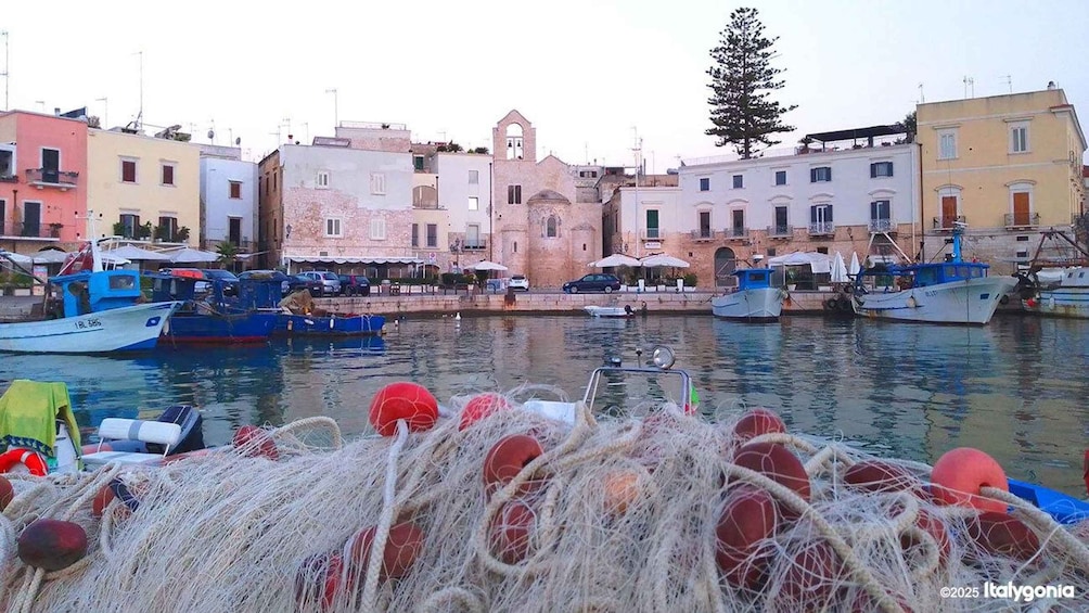 A harbor with boats, fishing nets, and colorful buildings. 5