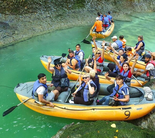 A group of people in yellow inflatable rafts on a river. 1