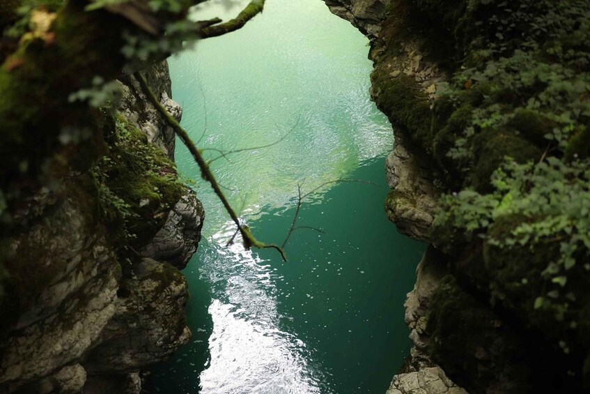 A narrow water passage framed by rocky cliffs with moss. 2