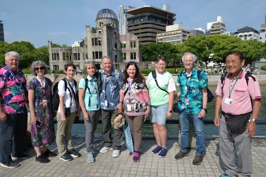 A group of people standing in front of a building with a dome and a tall tower. 3
