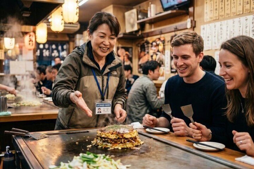 A street food vendor preparing food at a counter with customers watching. 1