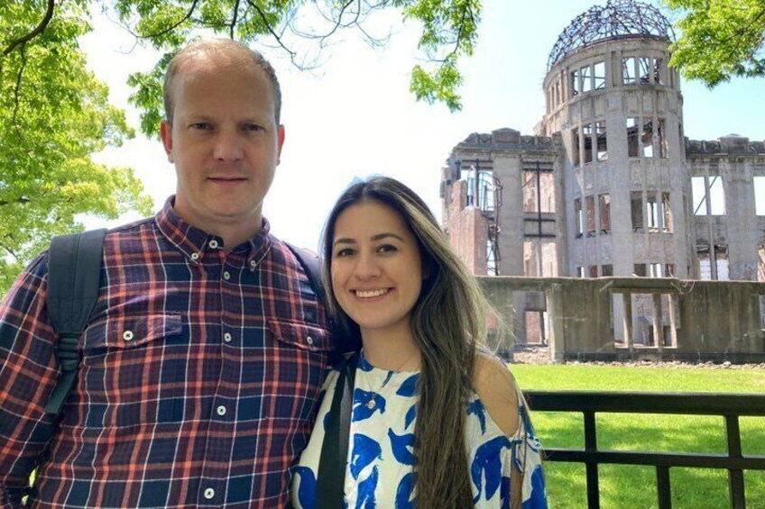 A man and woman standing in front of a large, historic building with a dome structure. 3