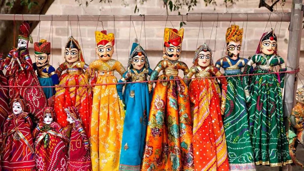 A row of colorful dolls dressed in traditional attire. 4