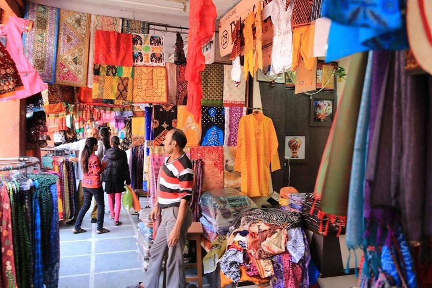 A market with colorful textiles and fabrics on display. 1