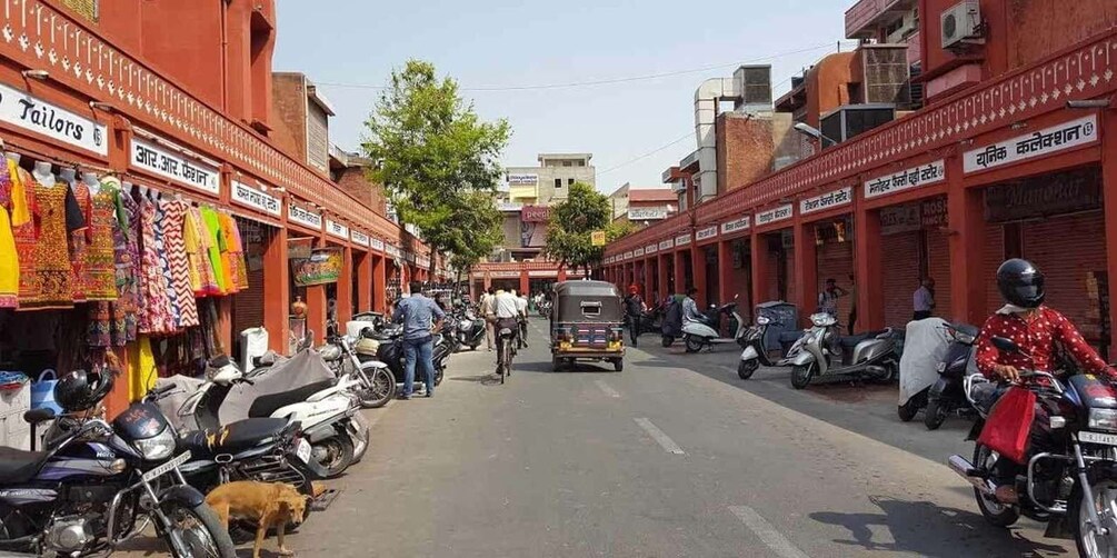 A street lined with shops and parked motorcycles. 3