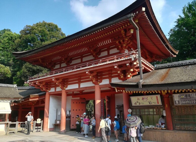 A traditional Japanese temple with red pillars and a thatched roof. 5