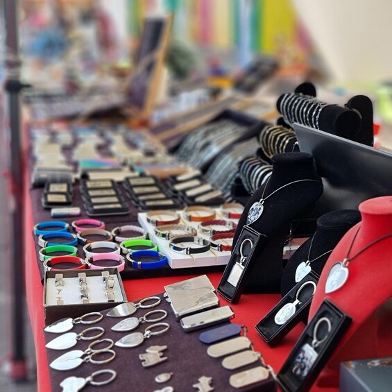A variety of jewelry displayed on a table, including bracelets, necklaces, and keychains. 4