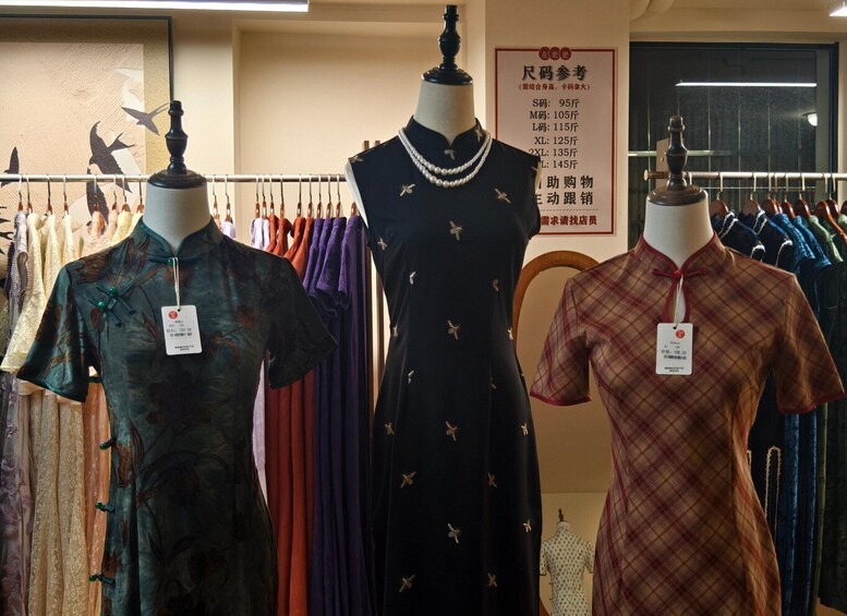 A clothing store with mannequins displaying dresses. 5