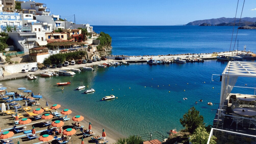 A coastal town with clear blue waters, boats, and a marina. 3