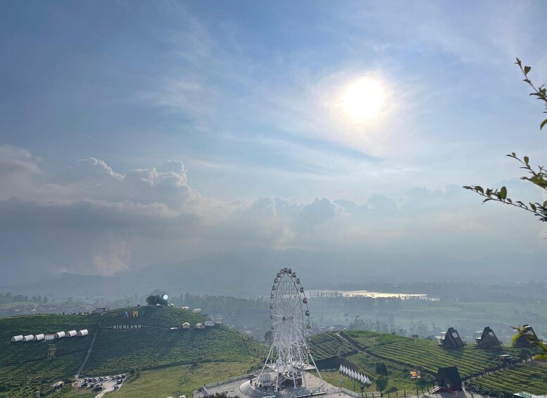 A Ferris wheel, tea plantation, and a distant view of a city. 3