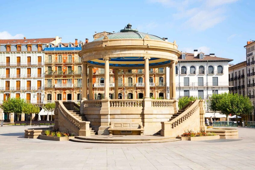 A historic rotunda with a dome, surrounded by classical architecture and a central staircase. 5