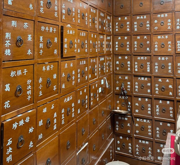 A wall of wooden storage boxes with Chinese characters. 3