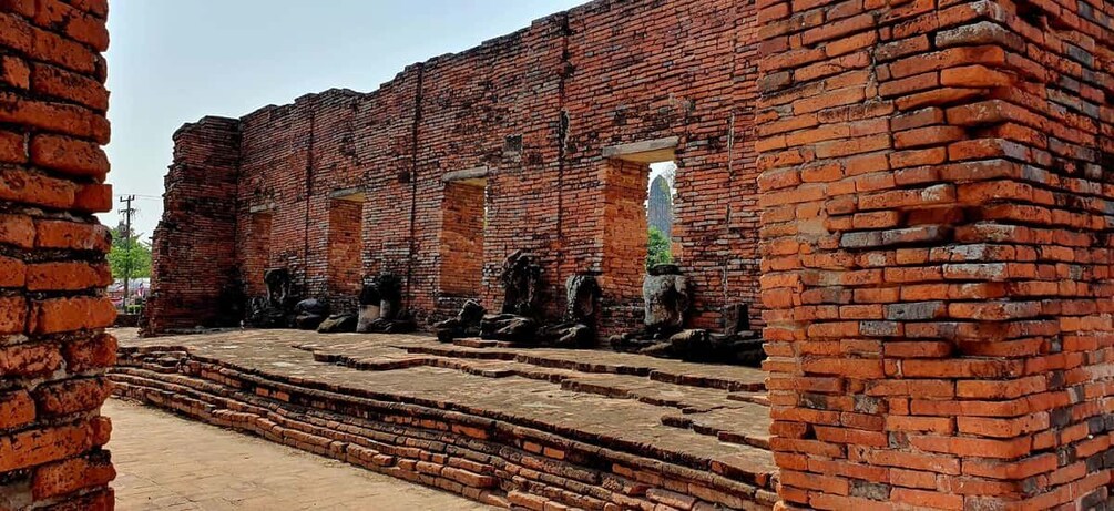 A brick structure with steps leading up to a doorway. 3
