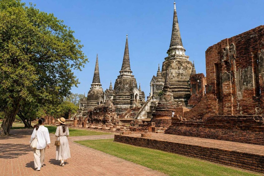 A temple complex with tiered spires and brick ruins. 1