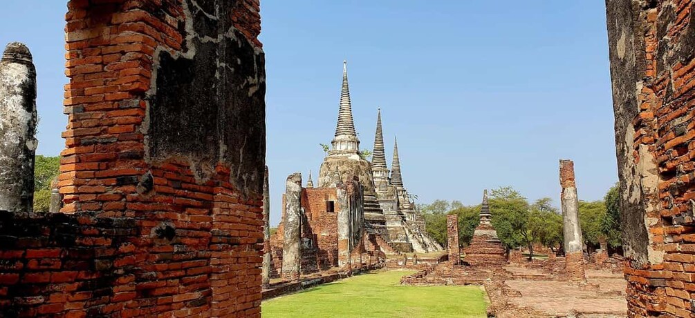 Ancient brick ruins with a temple in the background. 5
