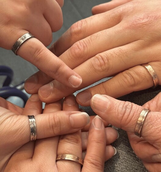 Multiple hands with rings, some of which appear to be worn. 1