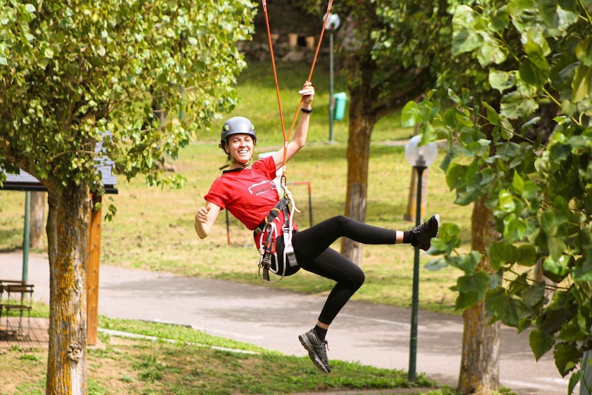 A person swinging on a rope swing in a park. 1