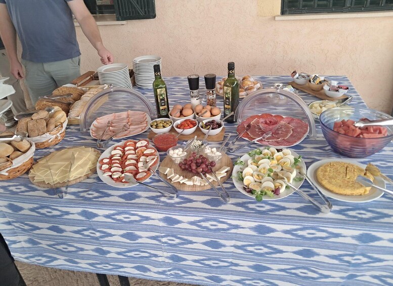 A buffet table with various food items, including meats, cheeses, and fruits. 3