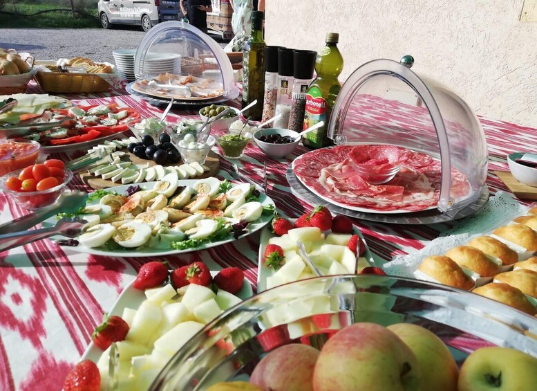 A buffet table with various food items including fruits, cheeses, and meats. 4