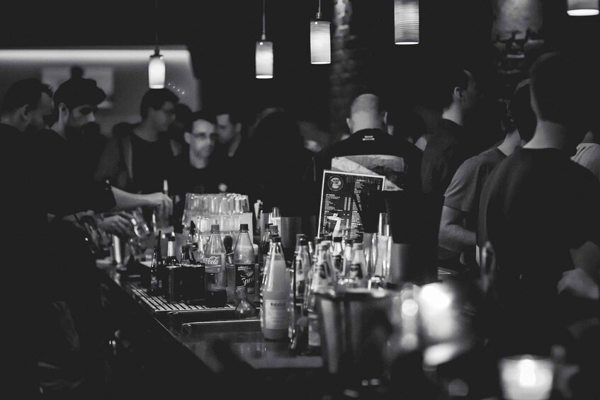 A bar with bottles and a menu. 2