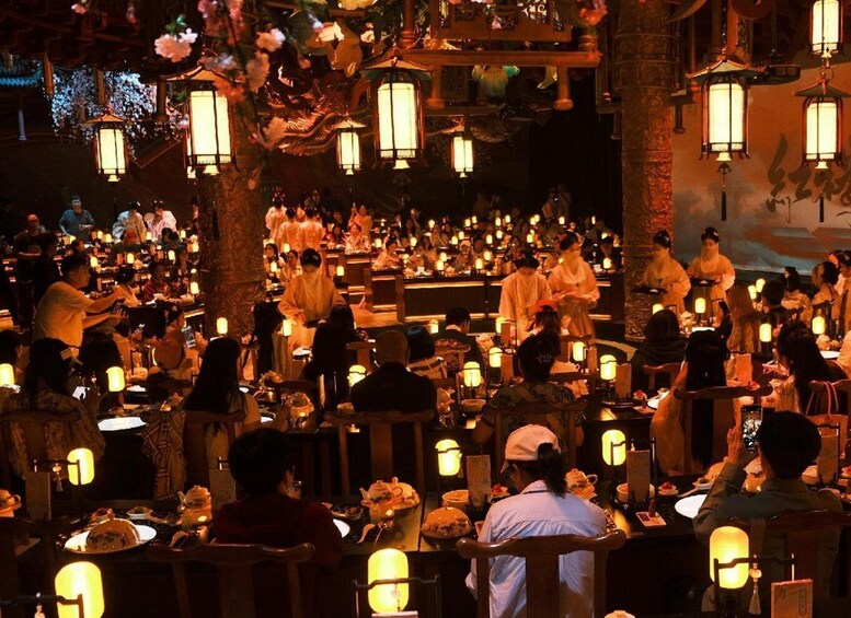A traditional Japanese restaurant with patrons dining under lanterns. 3