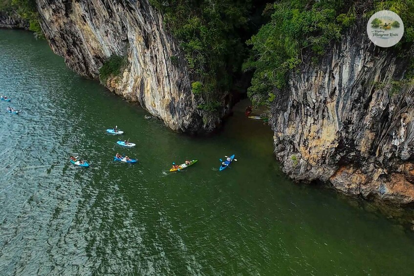 Kayakers navigating a river flanked by steep cliffs. 3