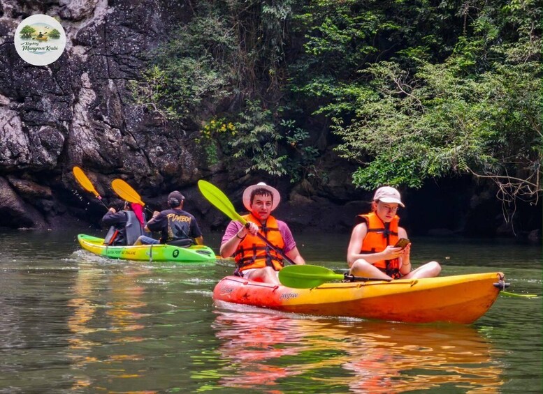 People kayaking on a river surrounded by rocky cliffs and lush greenery. 5
