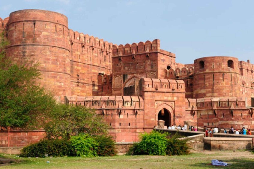 A large, historic fort with red brick walls and multiple towers. 3