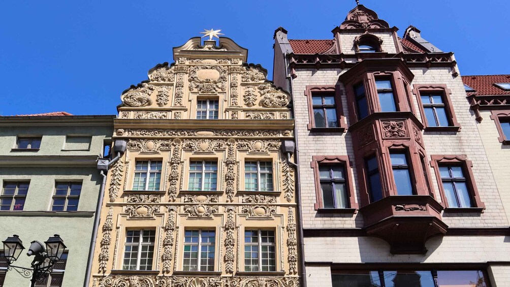 Ornate buildings with intricate architectural details and a clear blue sky. 4
