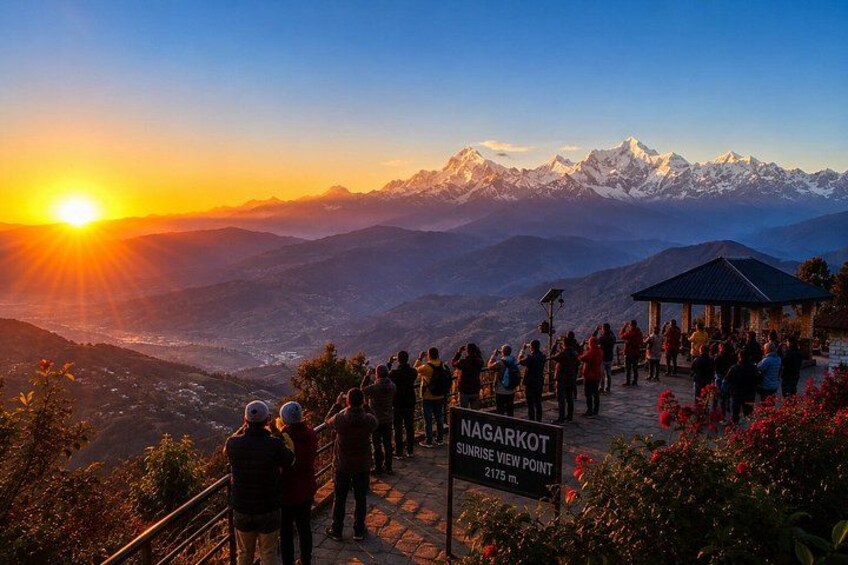 A sunrise at Nagarkot Sunrise View Point with a crowd of people, mountains in the background, and a clear sky. 4