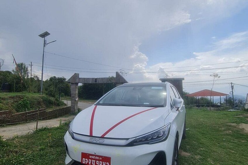 A white car with red stripes parked on a grassy area. 5