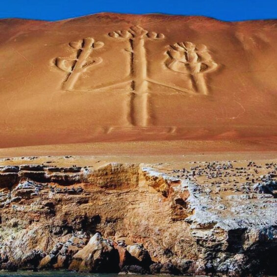 A desert landscape with a large sand dune and a rock formation in the foreground. 2