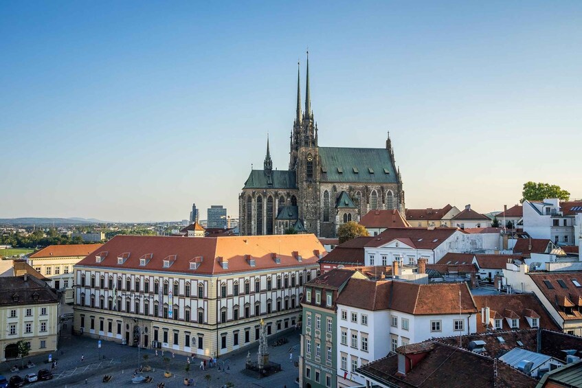 A historic cathedral with twin spires, surrounded by traditional European architecture. 1