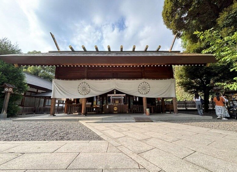 A traditional Japanese building with a wooden structure and a white canopy. 2