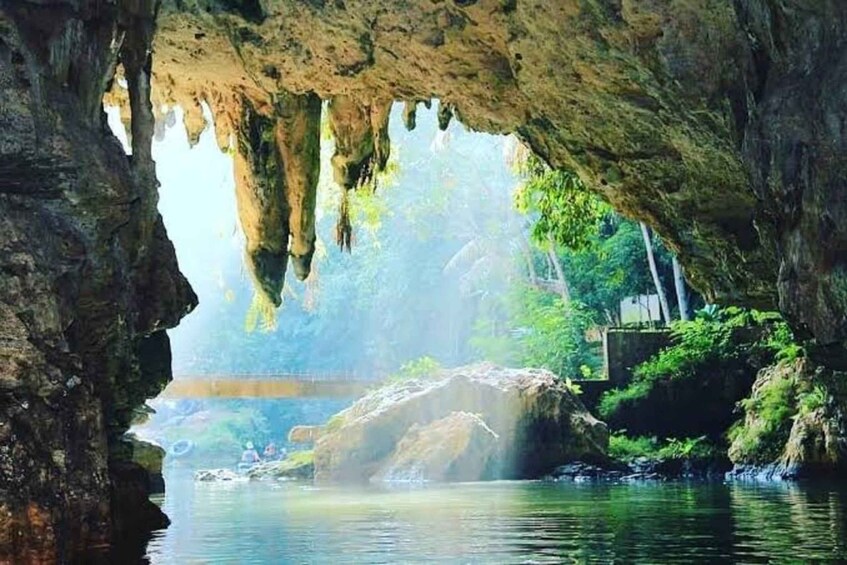 A cave entrance with water flowing through it. 5