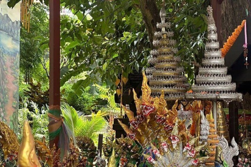 A temple with ornate architecture, surrounded by lush greenery and decorative elements. 3
