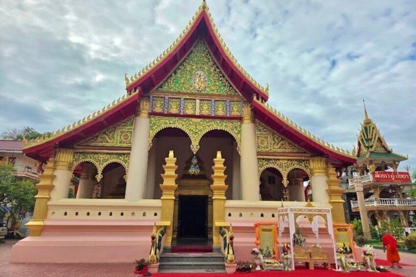 A traditional temple with ornate architecture, a red roof, and a golden facade. 5