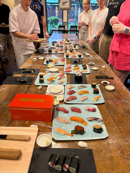 A sushi bar with various types of sushi displayed on plates. 1