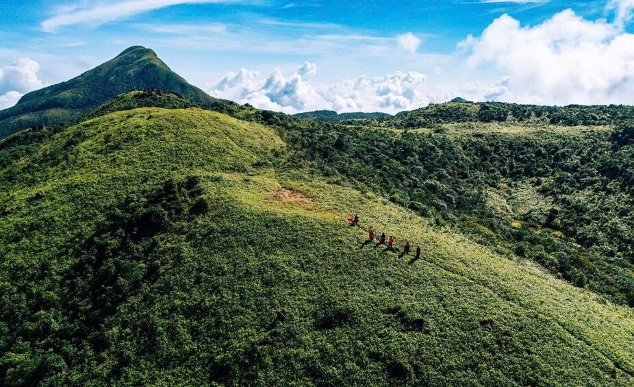 A mountainous landscape with dense green vegetation and a clear sky. 5