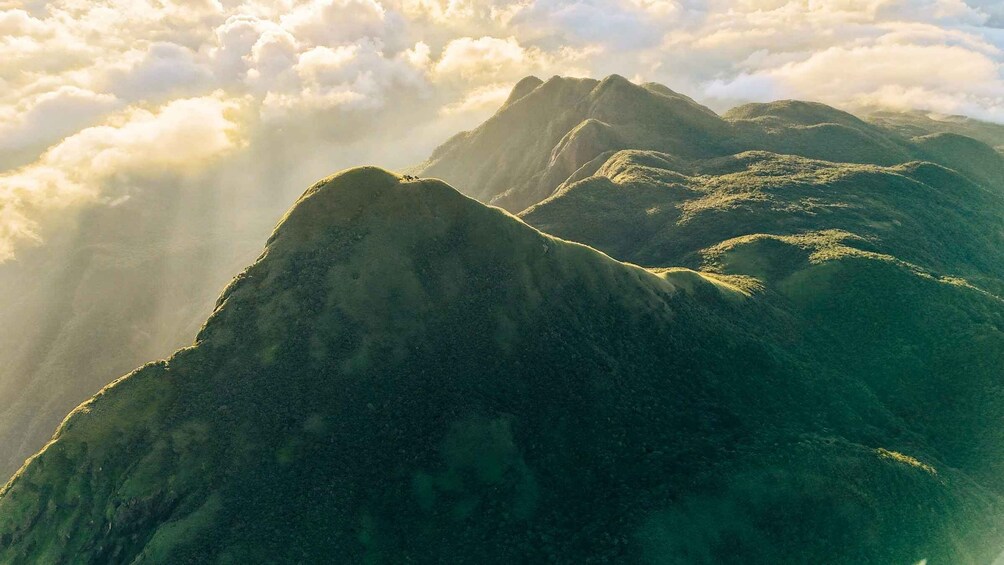 A mountain range with sunlight filtering through clouds. 4