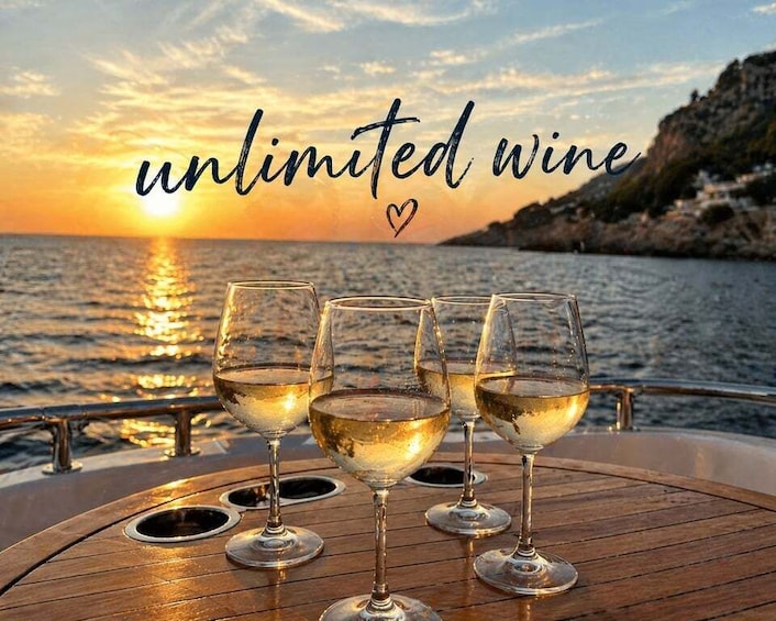 A sunset over the sea with three glasses of white wine on a boat. 1